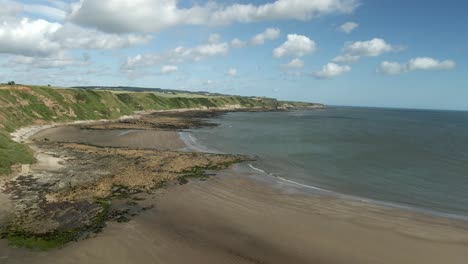 Aerial-descending-view-of-Jackson's-Bay,-North-Yorkshire,-Scarborough