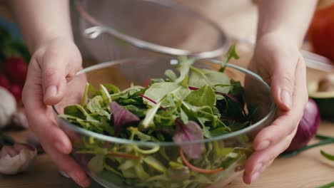 close up woman making healthy salat at home.