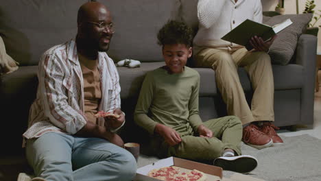 Black-men-and-boy-in-the-living-room-at-night