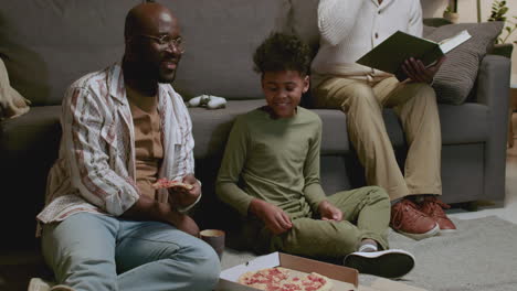 black men and boy in the living room at night