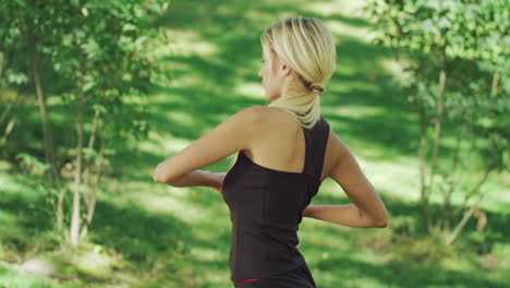 sport woman training stretching exercise in summer park. fitness woman