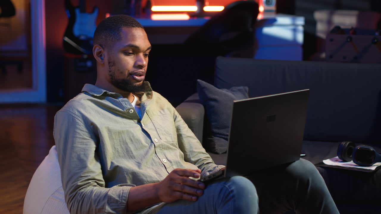 Vertical Video Black man joining online lesson to work on new skills from home space