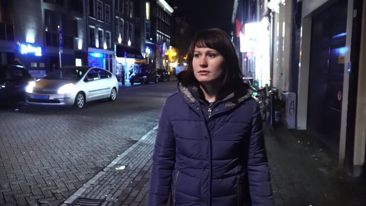 Girl tourist walk on evening Amsterdam