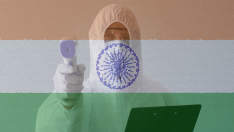 animation of healthcare worker in ppe suit using digital thermometer over indian flag