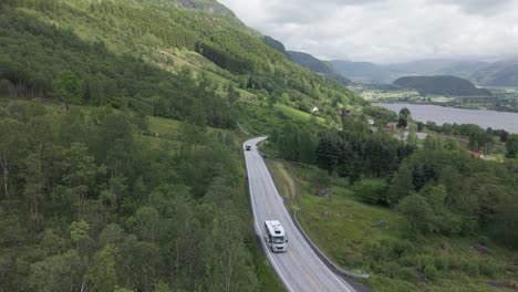 motor home and bus driving on the mountain road with ardalsfjorden in ardal, vestland, norway. - aerial shot
