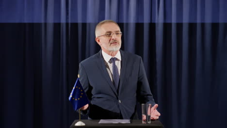 eu politician making announcement at press conference