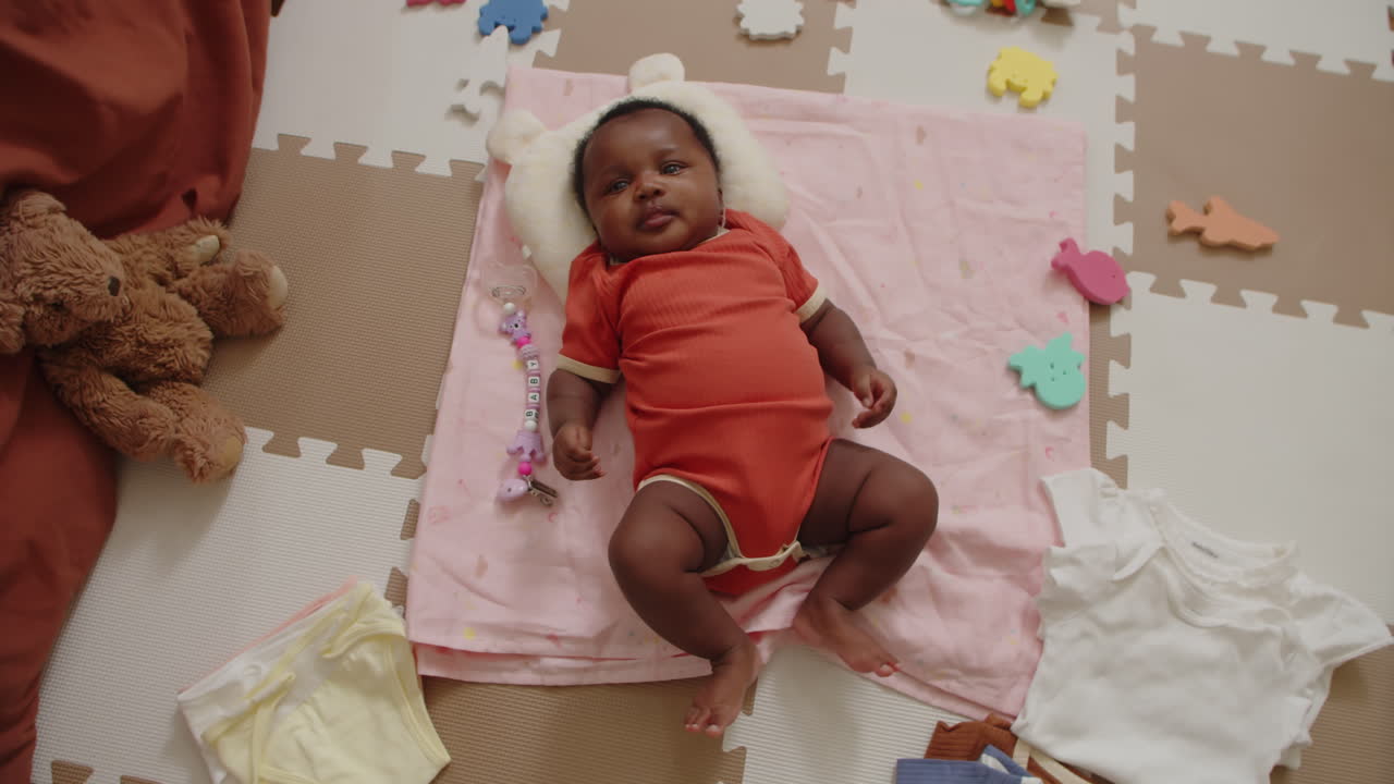 Newborn Girl Lying on Pink Blanket Top View