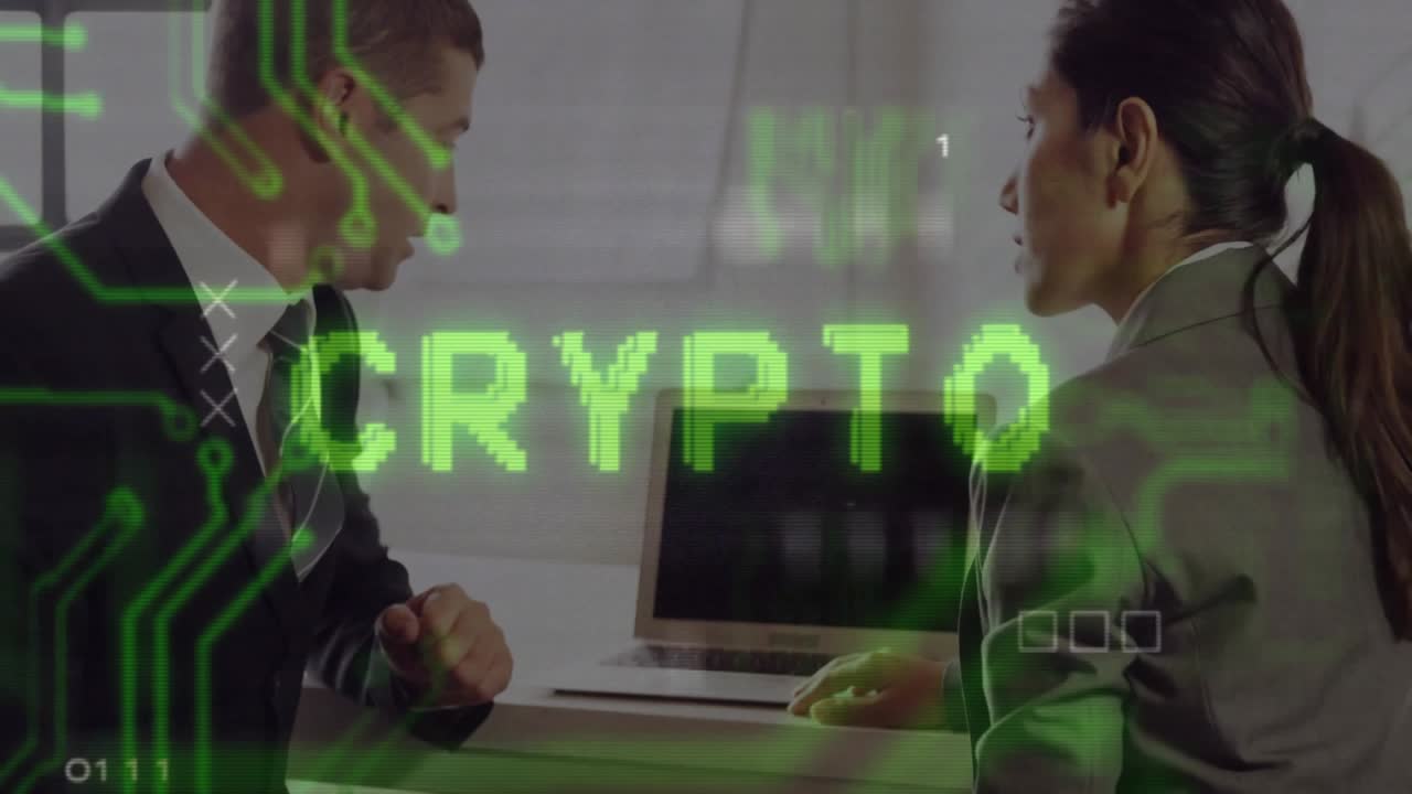 Coworkers sitting at desk pointing at laptop, starting animated crypto circuit overlay for analysis