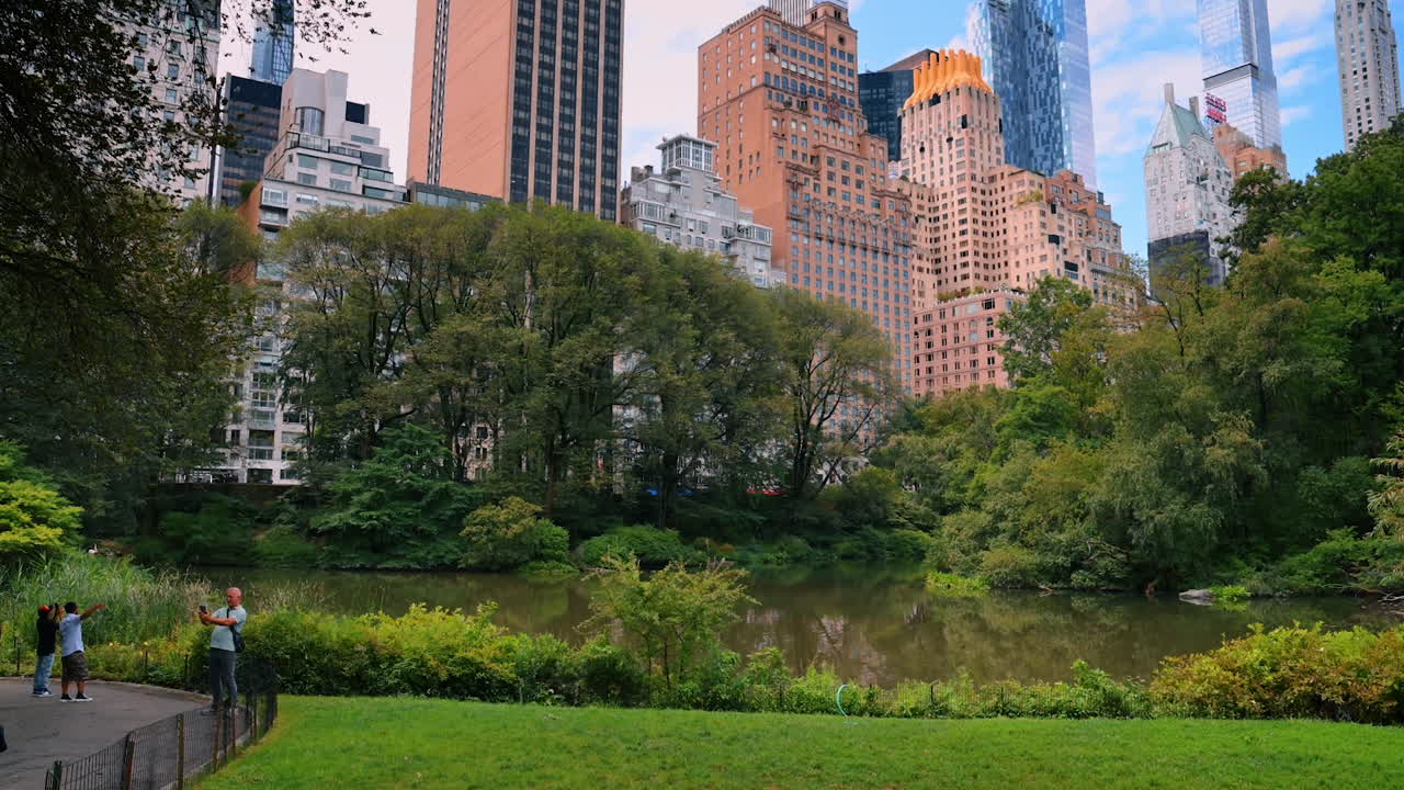 New York, USA, 28 July 2025: Visitors walk in Central Park. People enjoy a leisurely walk in Central Park, surrounded by skyscrapers