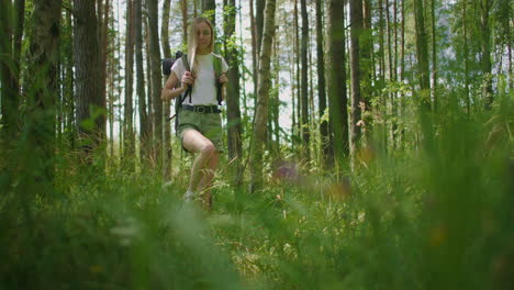 portrait of a woman walking a traveler with a backpack in a short in slow motion in the sunlight