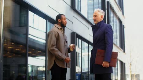 businessmen talking outdoors