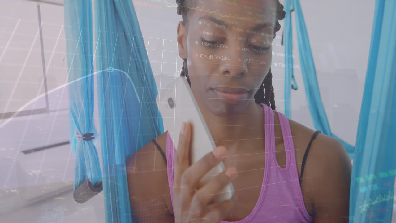 Animation of multiple graphs and trading boards, african american woman making call using cellphone
