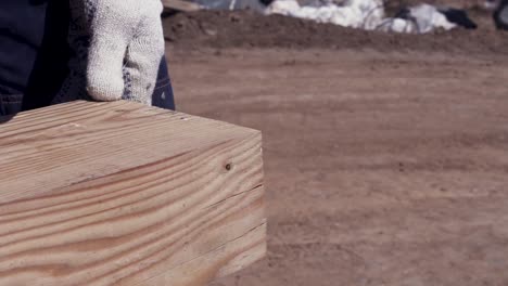 carpenter using a hammer to work on wooden beams