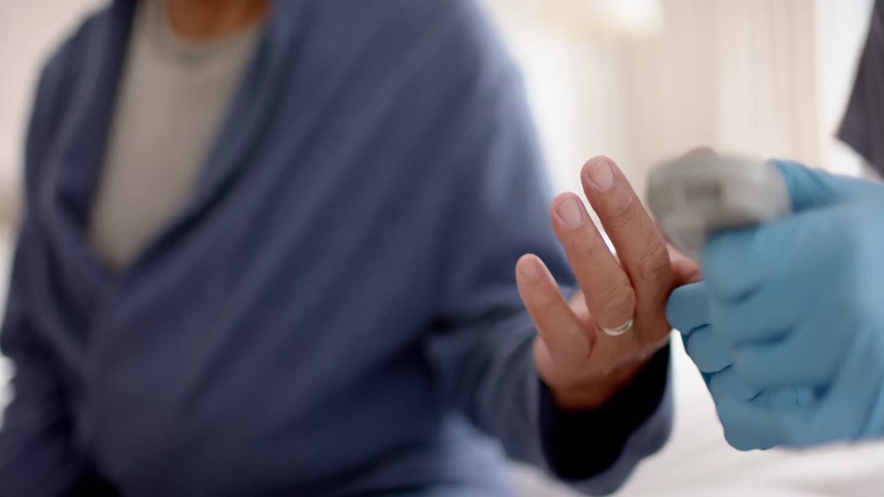 средний раздел разнообразного мужского врача, тестирующего кровь пожилого мужчины-пациента дома, замедленное движение