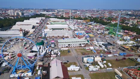 olympia-roller-coaster-Spectacular-aerial-top-view-flight-Theresienwiese-october-festival,-sunny-day-before-opening