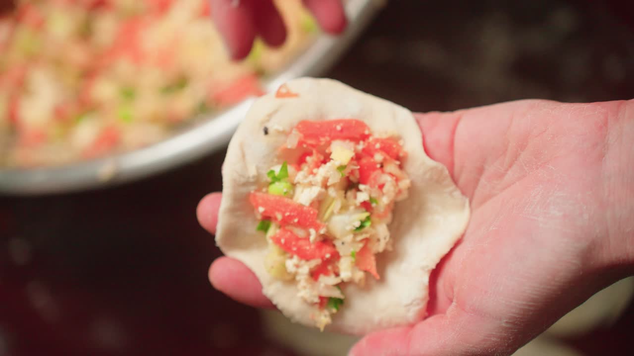 Filling and folding dumplings by hand