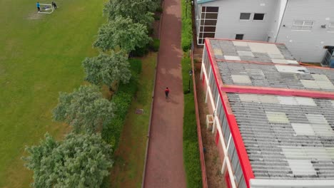 AERIAL-VIEW:-Man-running-through-King-George's-park-in-London-UK