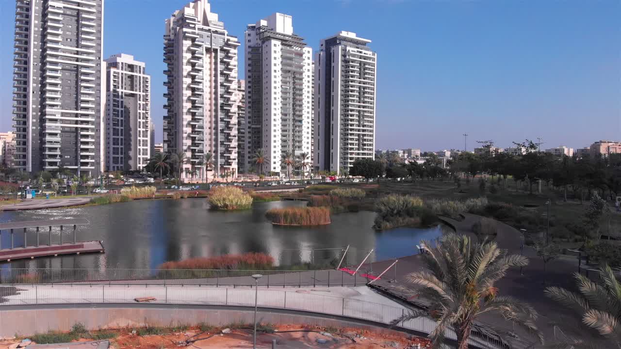 Urban Park with Lake and Modern High-Rise Buildings
