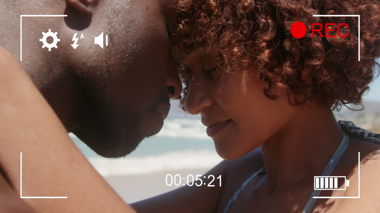 Filming a couple on a beach on a digital camera 4k