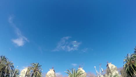 soap baloons in barcelona park against blue sky, 4k