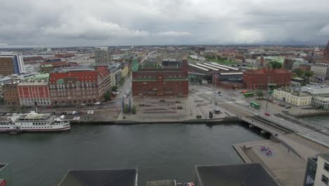 aerial drone shot flying over canal and city buildings in malmö, sweden