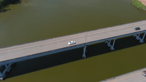 aerial of cars driving on bridge that crosses over the san jacinto river in houston, texas