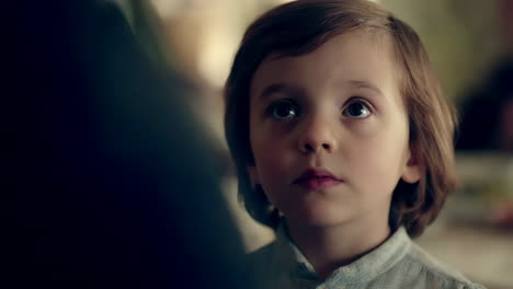 a young child with an innocent and curious expression looks upwards