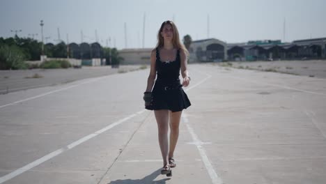 young woman walking in urban parking lot