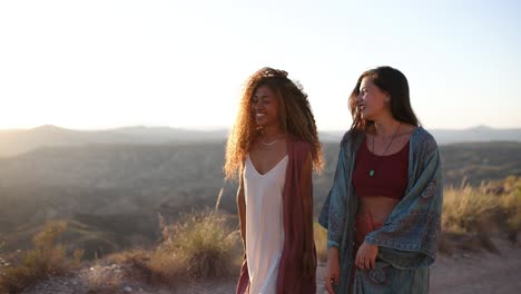 two women enjoying a sunset landscape