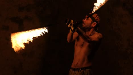 slow motion shot of a man performing with a fire whip