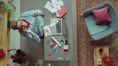 fashion designer speaking on phone at workplace