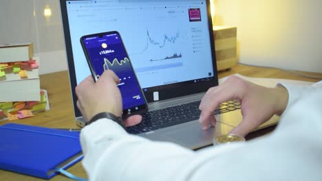 Young-Professional-Businessman-Holding-Phone-And-Bitcoin-In-His-Hands