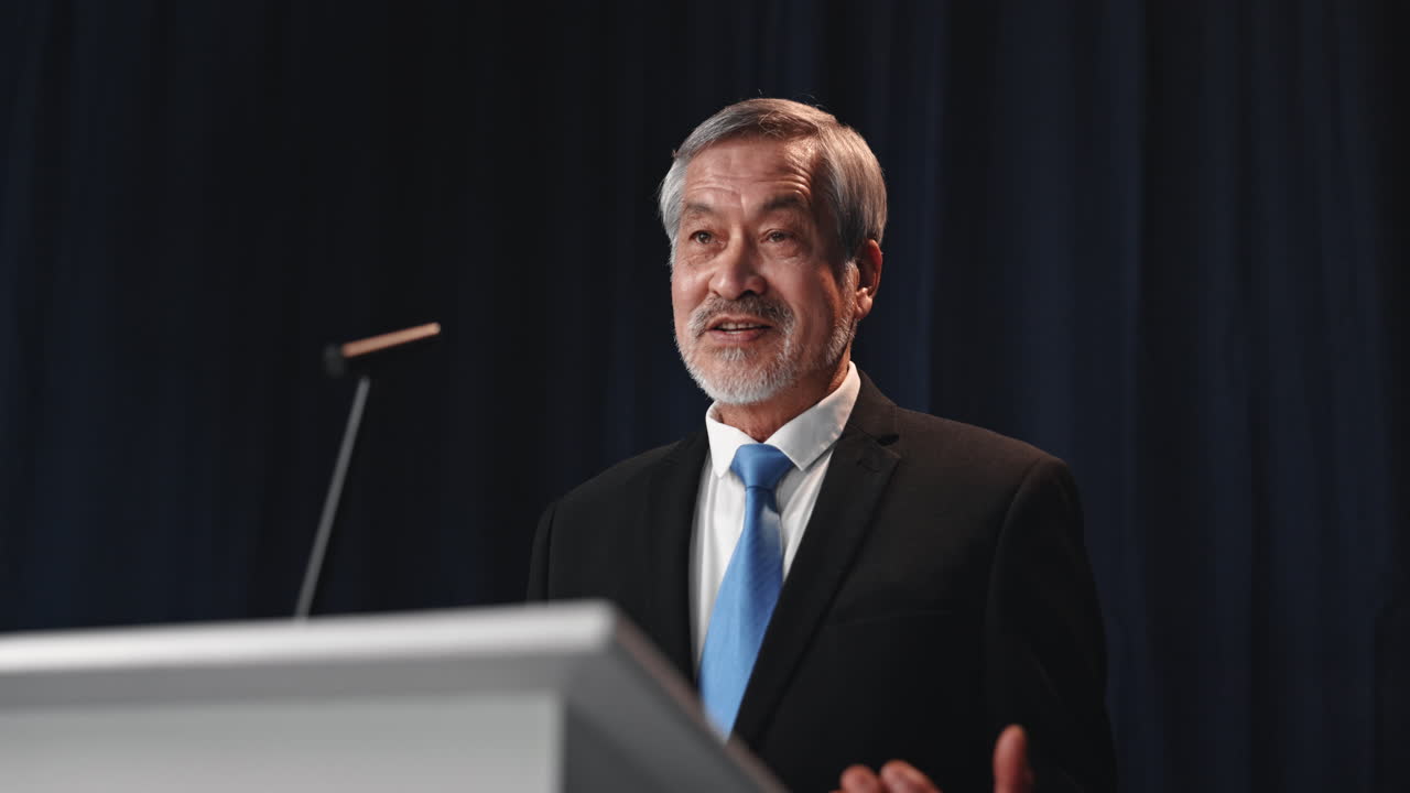 Man giving a speech at a podium