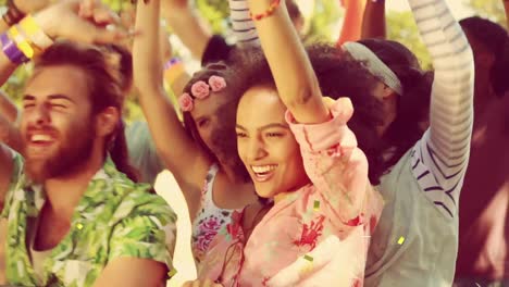 animation of gold confetti falling over happy people dancing outdoors