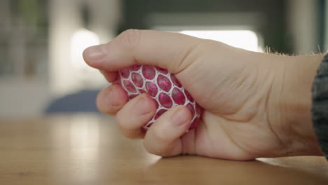 person holding a pink glitter stress ball