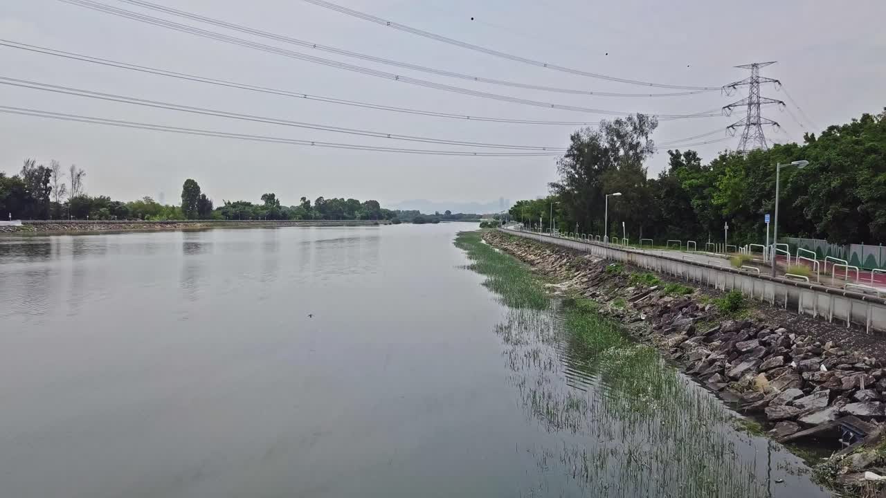 홍콩 위엔 롱 타운을 따라 고압 전기 타워와 케이블의 역동적인 공중 촬영