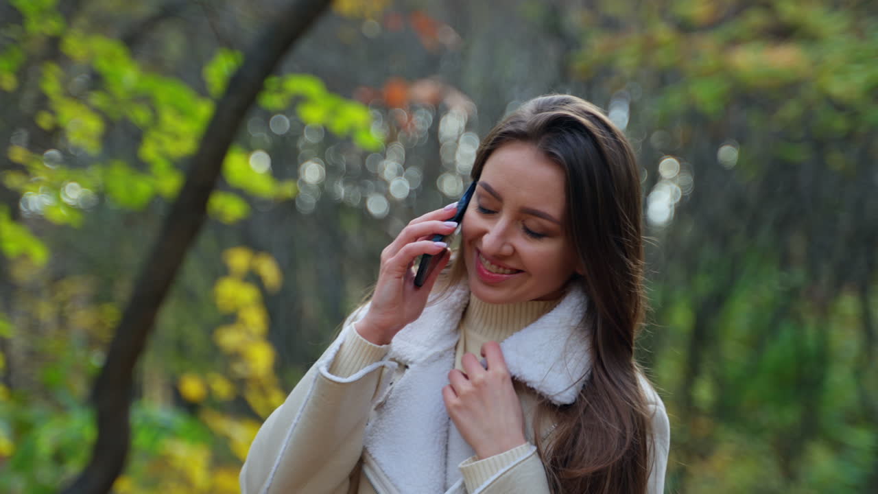 Woman Enjoying a Fall Day with Phone Calls