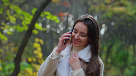 woman enjoying a fall day with phone calls