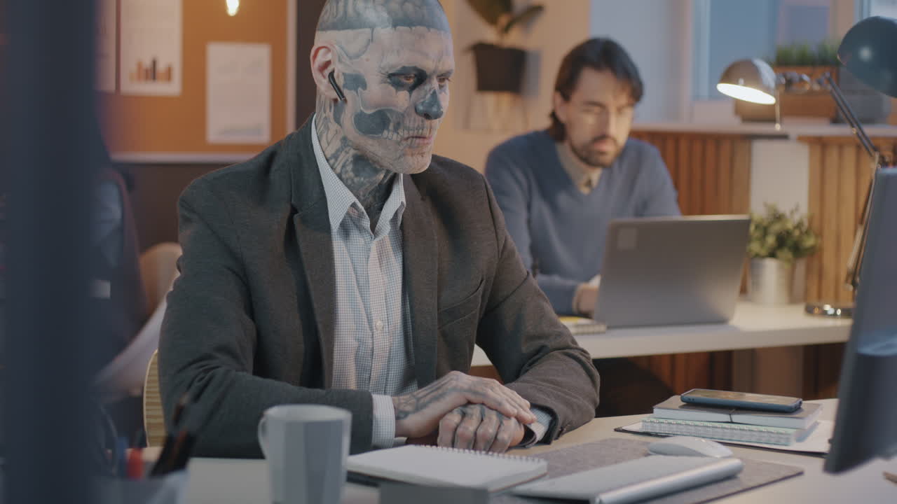 Businessman with Skull Tattoo in Office