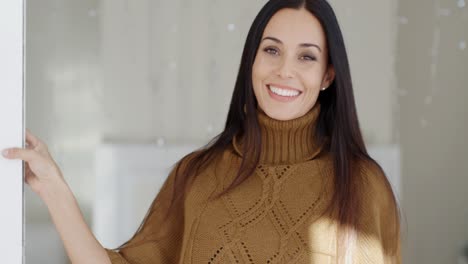 Happy-vivacious-young-woman-indoors-at-home