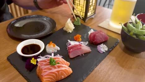 sushi and sashimi served with soy sauce