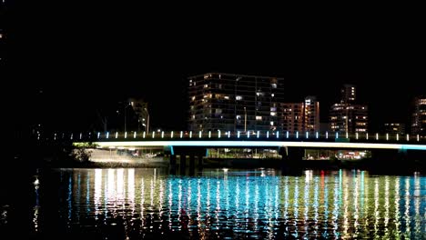 city lights reflecting on water at night