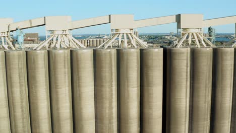 Aerial-view-rows-of-tall-concrete-grain-storage-silos-in-Duluth-Minnesota---drone-tracking-day