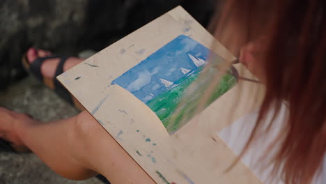 woman painting a watercolor seascape