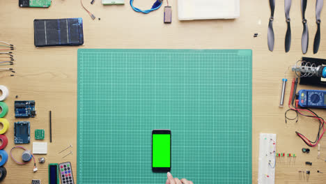 Top-view-woman-software-engineer-using-smartphone-touchscreen-at-desk-from-above---Red-Epic-Dragon