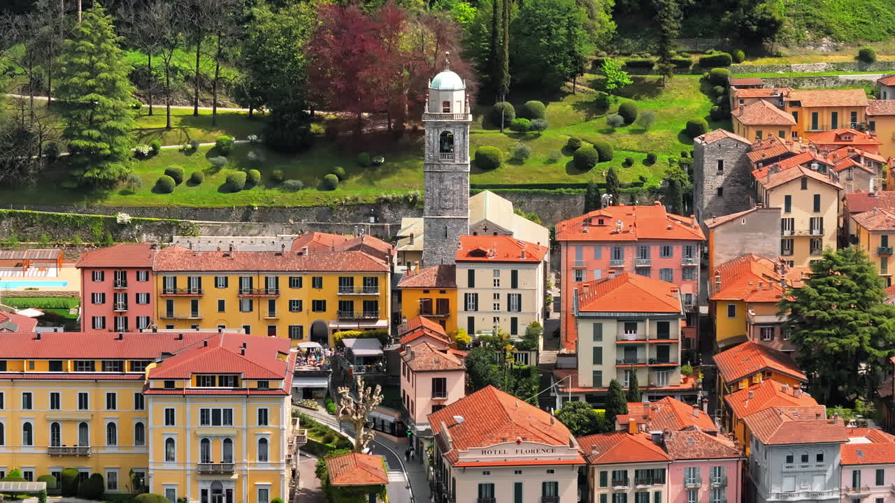 Aerial drone view of the Basilica of St. Giacomo surrounded by houses in Bellagio, Italy