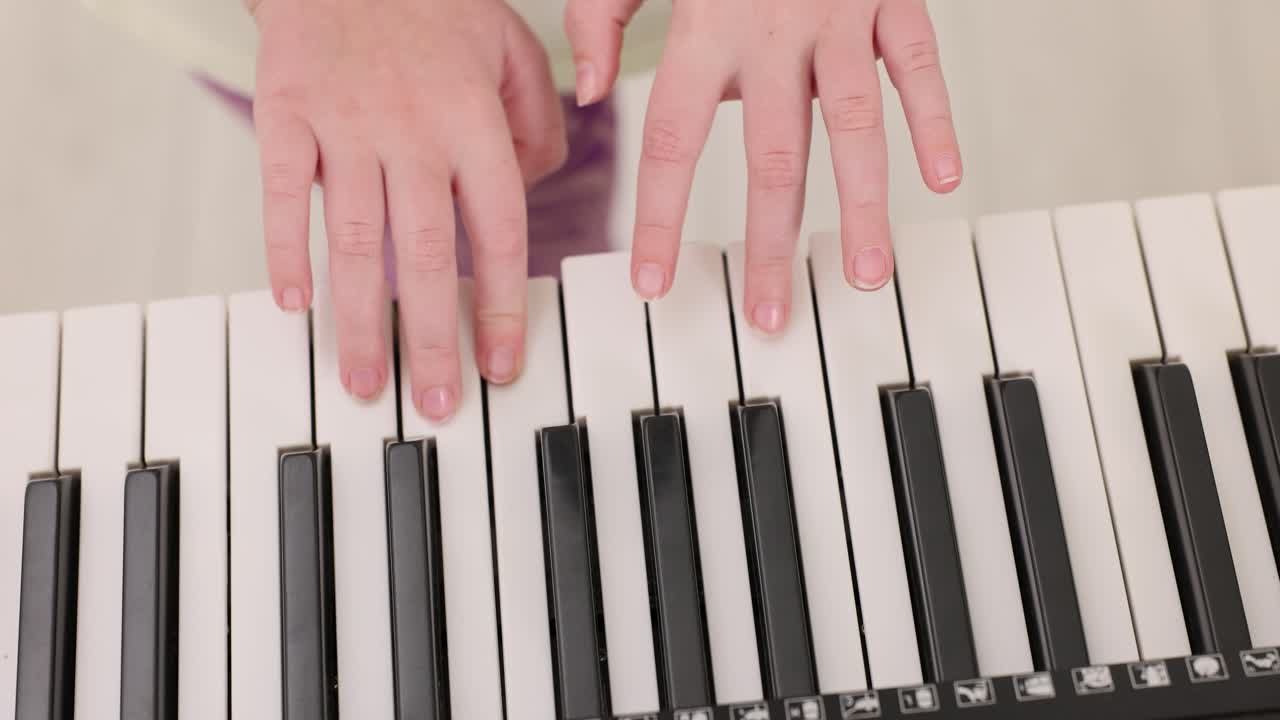 Hands playing the piano keyboard