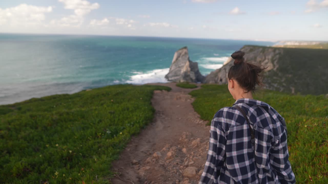 Woman Hiking Along a Coastal Path