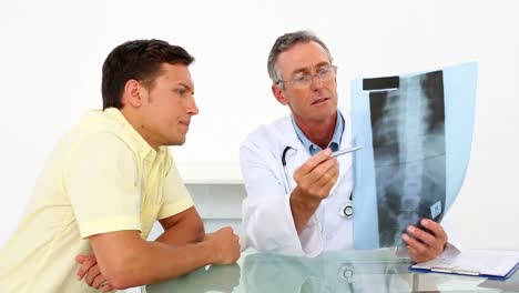 Doctor-showing-spine-xray-to-his-patient