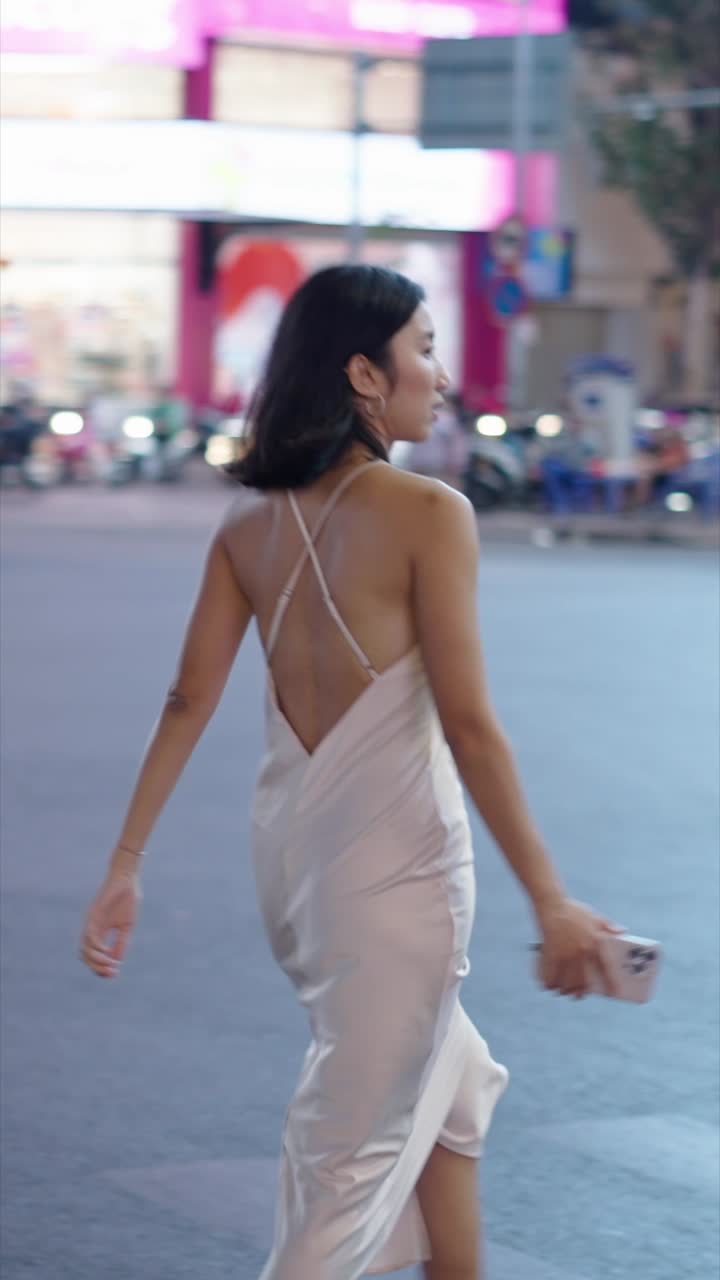 Woman in a Dress Walking on a City Street at Night | Premium Stock ...
